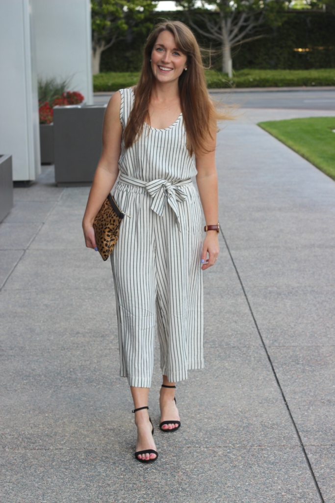 Black and white striped GAP jumpsuit with leopard clutch and black heeled sandals 