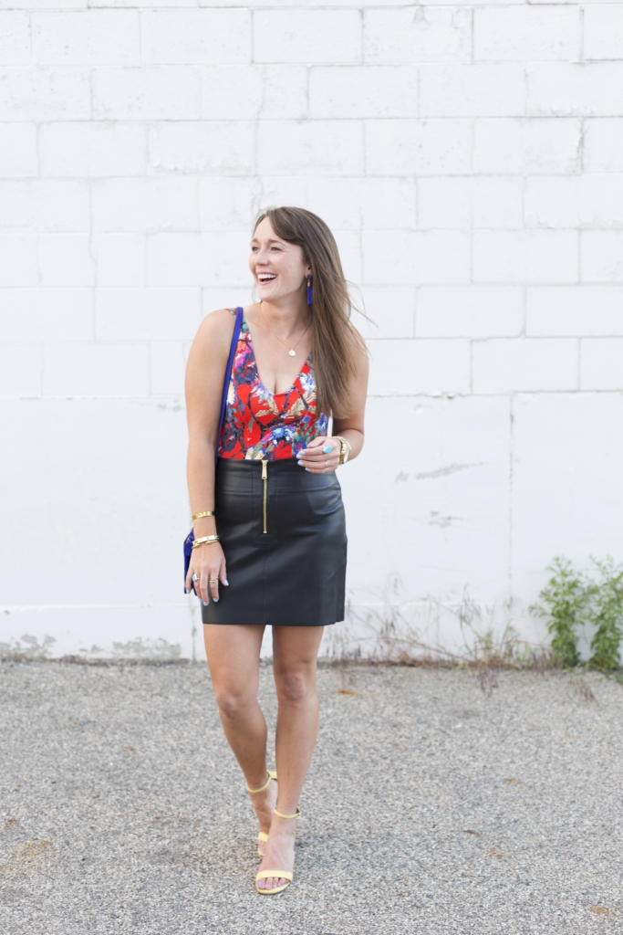 Floral bodysuit with leather mini skirt and tassel earrings