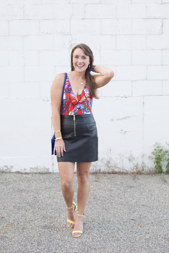 Floral bodysuit with leather mini skirt and tassel earrings