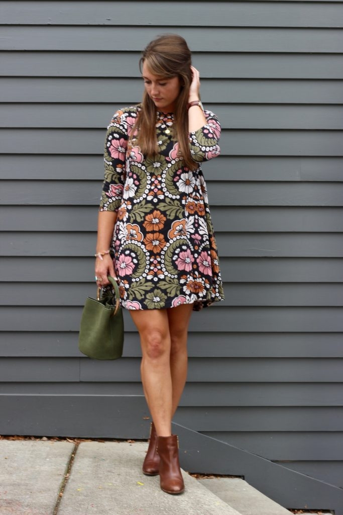 Fall floral dress with ankle boots and green bucket bag