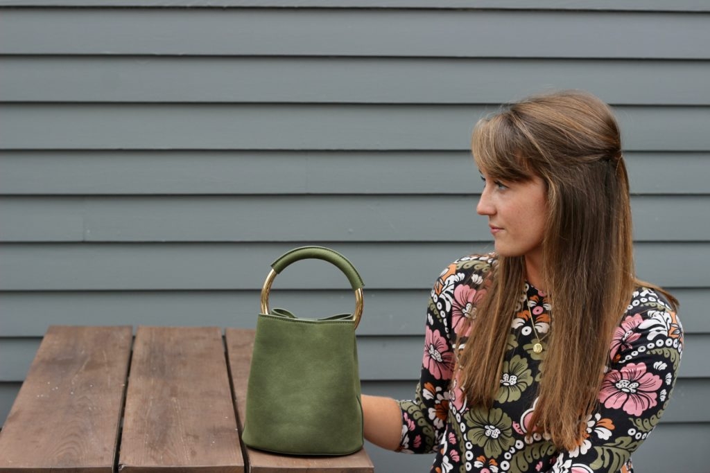 H&M fall floral dress with leather ankle boots and green bucket bag