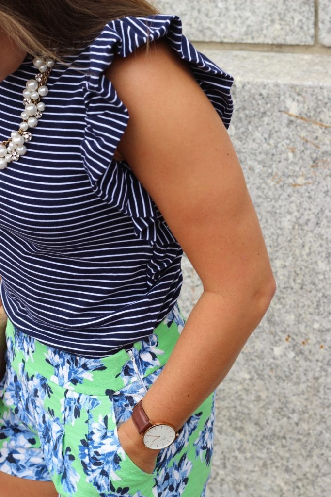 Green floral shorts with striped ruffled top and Converse sneakers