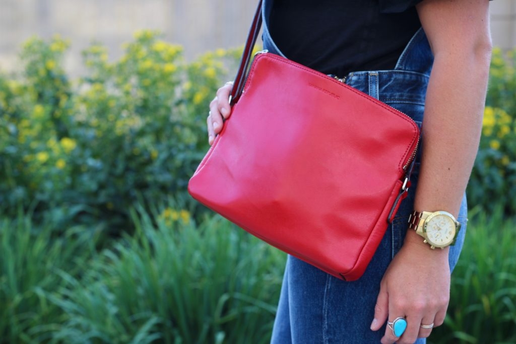 Levi's overalls with Black tee, leopard mules and red crossbody purse