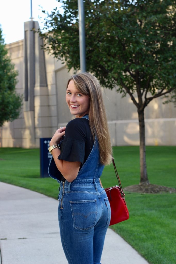 Levi's overalls with Black tee, leopard mules and red crossbody purse