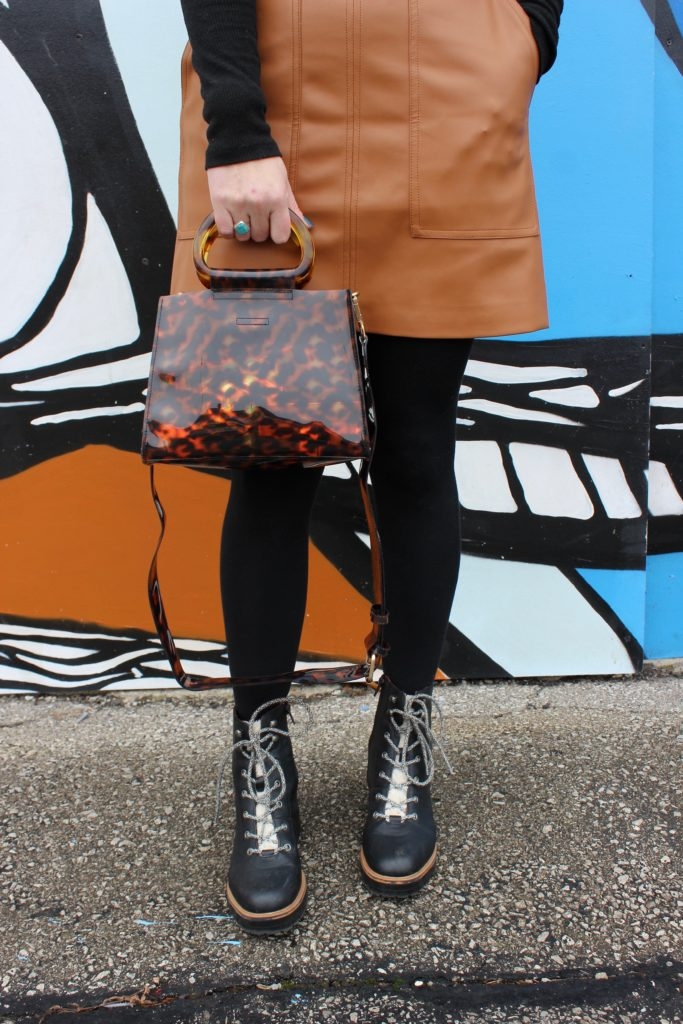 Simple winter style with a turtleneck and camel skirt on Cassidy Lou