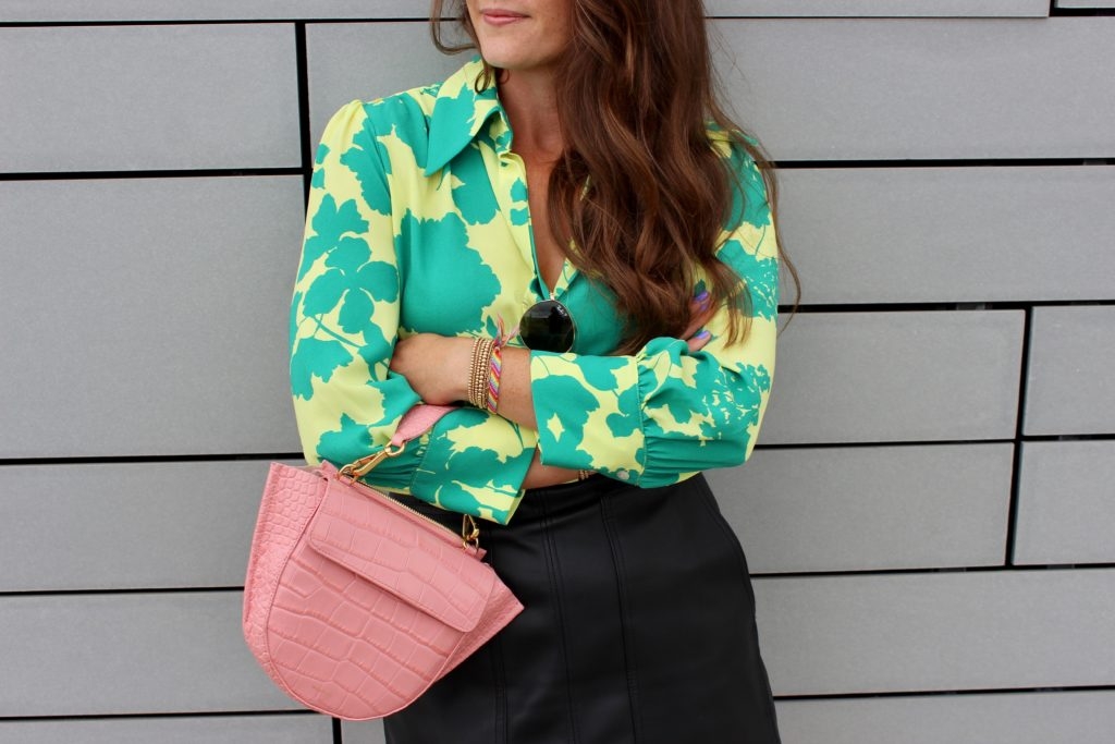 styling a black faux leather skirt for summer with bright floral blouse on Cassidy Lou 